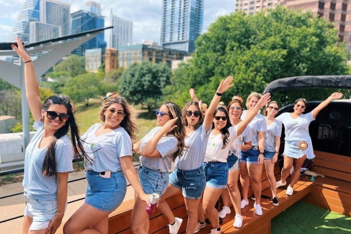 a group of people standing around a bench