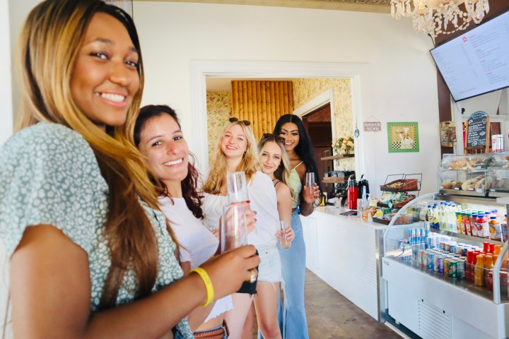 a woman standing in front of a refrigerator