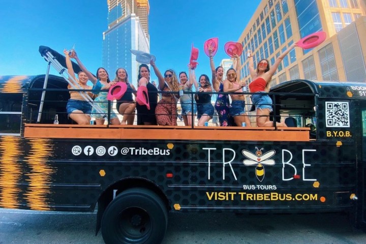 a group of people riding on the back of a truck
