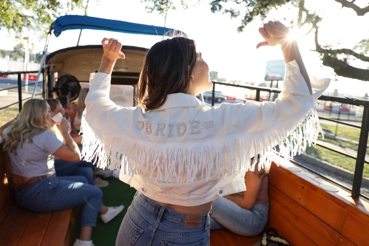a little girl standing next to a person
