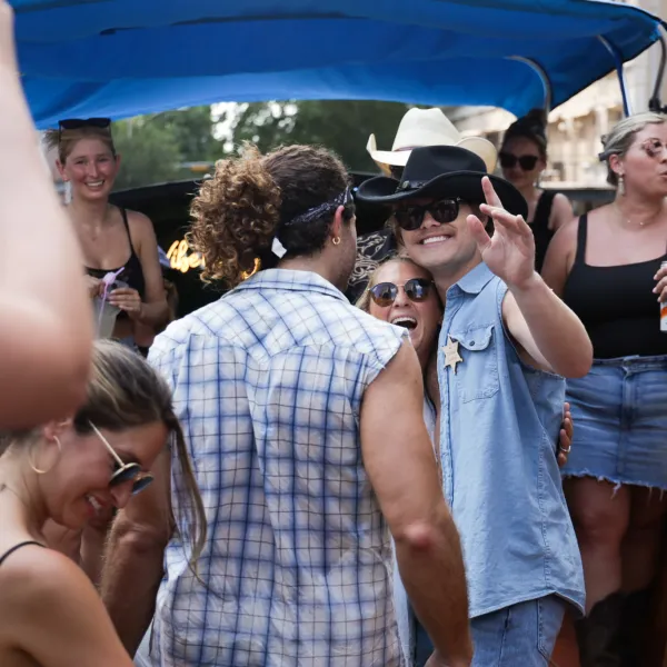 a group of people are drinking from the water