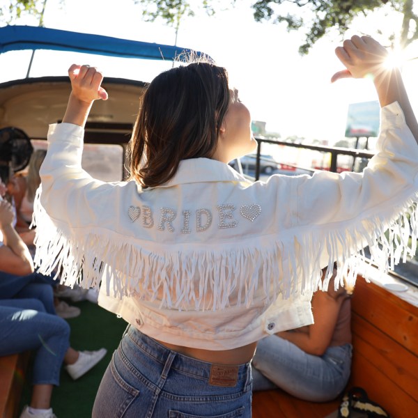 a little girl standing next to a person