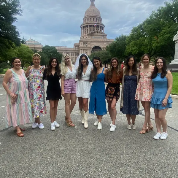 a group of people standing in front of a crowd posing for the camera