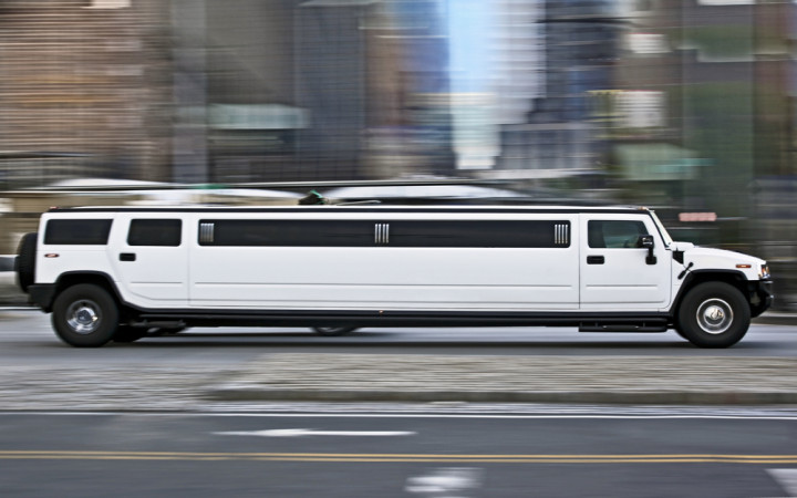 a silver truck driving down a street